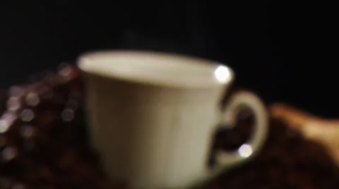 Steaming cup of coffee and coffee beans Stock Footage 8571449
