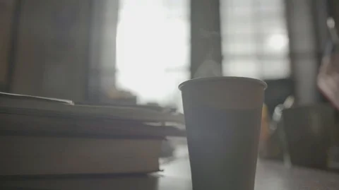Steaming Cup of Coffee Beside Paperwork on a Table HD Video Stock Footage 90956545