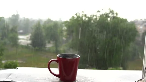 Steaming cup of coffee over a cityscape background Stock Footage 134491281
