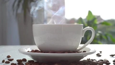 A steaming cup of hot coffee stands on the table. Stock Footage 161171044
