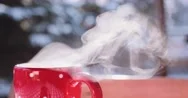 Steaming Cup Of Hot Drink In Snowy Winter Morning. 4K Dci Slow Motion 120 Fps. Stock Footage