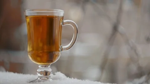 Steaming Cup Of Hot Tea In Snowy Winter Stock Footage 71290202