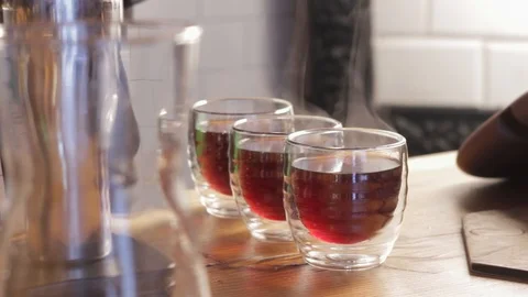 Steaming cups of coffee or tea on a table close up. Stock Footage 126852673