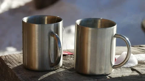 Steaming Cups of Hot Drink in a Winter Landscape Stock Footage 230491687