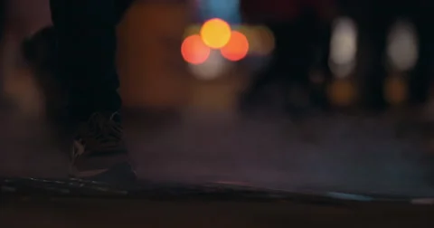 Steaming drain and walking people in night city Video stock 64766713