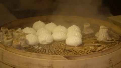 Steaming Dumplings and Buns in Bamboo Basket at Beijing Street Food Stall Stock Footage 345857009