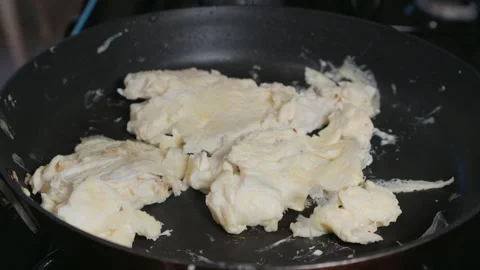 Steaming eggs in a skillet Stock Footage 296572131