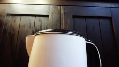 Steaming Electric Kettle, Low-Angle CU, Bright Yellow Spotlight, HD Stock Footage 219770705