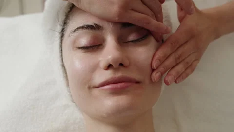 Steaming the face to open pores, applying liquid cream to open pores. Therapy Stock Footage 249280212