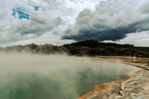 Steaming Geothermal Pool Under Dramatic Storm Clouds Stock-Fotos