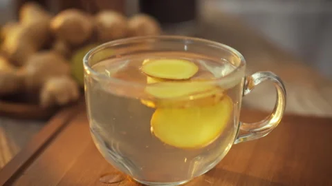 Steaming ginger tea in a transparent mug fills the kitchen with an aroma of Stock Footage 331361906