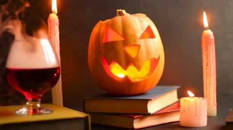 Steaming head Halloween Jack pumpkin on the table near a glass with smoke Stock Footage 68417014