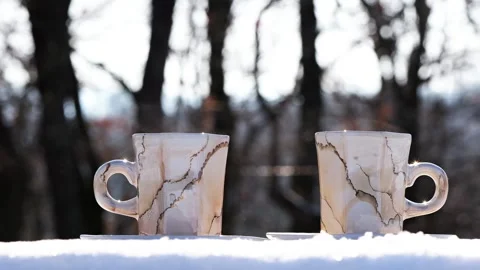Steaming Hot Coffee Cups on Snow Near Forest on Sunny Winter Day 2026 Stock Footage 327041165