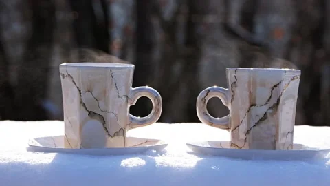 Steaming Hot Coffee Cups on Snow Near Forest on Sunny Winter Day BG Stock Footage 327041172