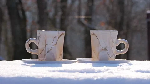 Steaming Hot Coffee Cups on Snow Near Forest on Sunny Winter Day Stock Footage 327041174