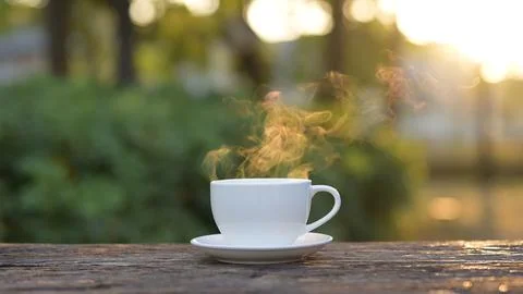 Steaming hot coffee mug surrounded by nature an espresso and americano Stock Photos