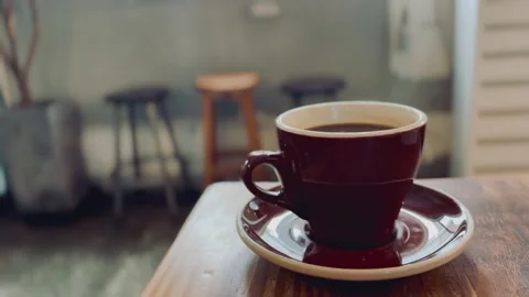 Steaming hot cup of coffee with rising vapor, close-up Video stock 329285053