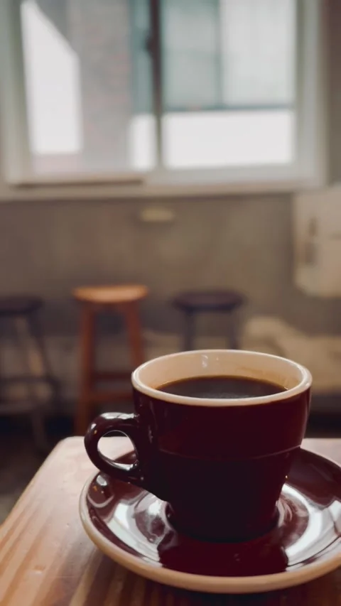 Steaming hot cup of coffee with rising vapor, close-up Video stock 329285054