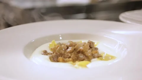 Steaming hot dish with meat and pasta in a restaurant kitchen Stock Footage 169370335