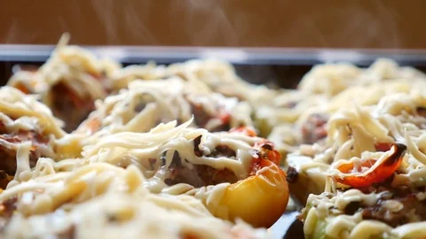 Steaming, hot, freshly baked, stuffed zucchini on a baking sheet. close-up of Stock Footage 80686443