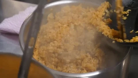 Steaming hot fried rice cooked in a metal pan closeup Video stock 347688014
