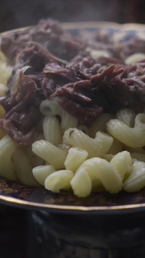 Steaming hot pasta with beef stew and meat. Vertical. Close up Stock Footage 330912746