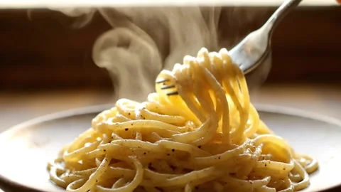 Steaming hot spaghetti twirled on a fork coated in a creamy sauce and seaso.. Stock Footage 324559648