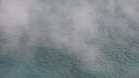 Steaming hot spring pool zoom out slow motion Yellowstone Stock Footage 312002752