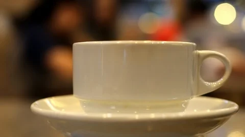 Steaming hot tea or coffee in a cup. Waiting someone in a restaurant. Stock Footage 93009231