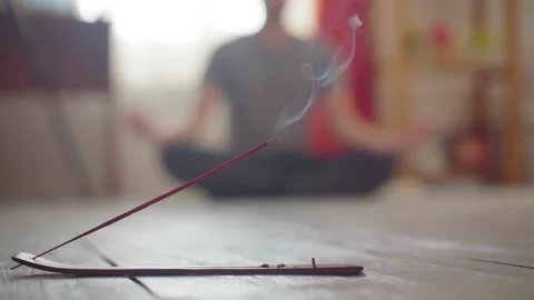 Steaming incense stick close-up on the floor Stock Footage 148228153