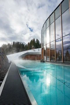 Steaming infinity pool by glass spa, Oberlech, Austria, winter alpine scene Stock Photos