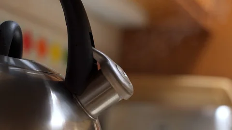 Steaming kettle on a kitchen stove Stock Footage 94299993