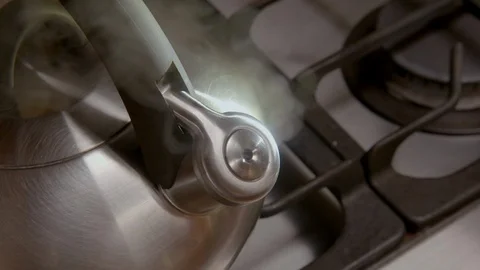 Steaming kettle on a kitchen stove Stock Footage 94916674