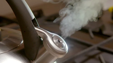 Steaming kettle on a kitchen stove Stock Footage 94916995