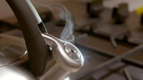 Steaming kettle on a kitchen stove Stock Footage 94917080