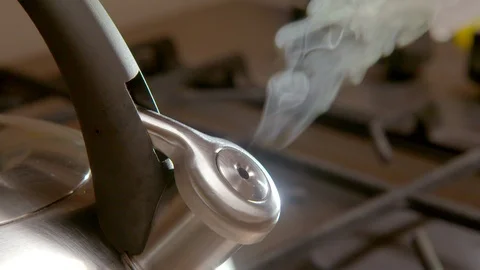 Steaming kettle on a kitchen stove Stock Footage 94917210