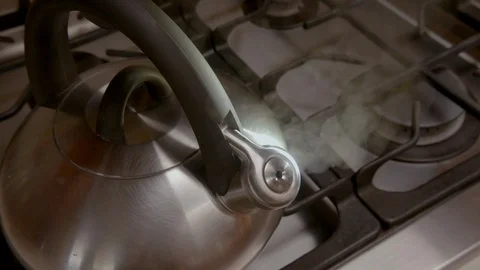 Steaming kettle on a kitchen stove Stock Footage 95144876