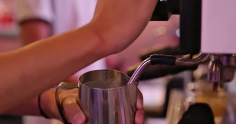 Steaming milk for latte coffee from a coffee machine Stock Footage 301747878