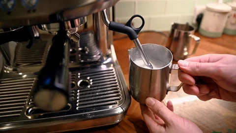 Steaming milk for a perfect latte or cappuccino at home Stock Footage 125581179