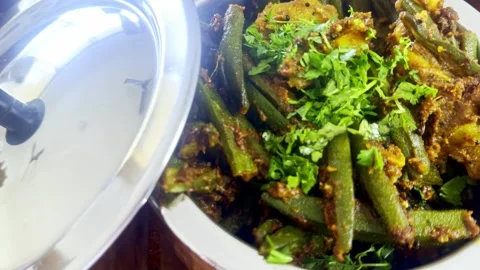 Steaming okra dish served in round metal container Stock Footage 304850950