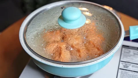 Steaming Orange Dumplings Under Glass Pot Lid Stock Footage 341373781