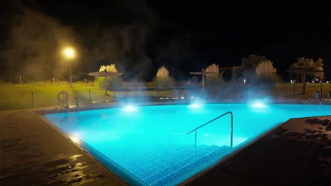 Steaming Outdoor Thermal Pool at Night with Blue Lights Video stock 335053388