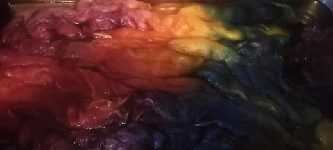 Steaming pan of freshly hand dyed wool roving fiber in rainbow colors Stock Footage 170861618