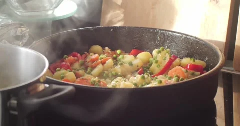 Steaming from a pan with mixed vegetables 4K video Stock Footage 299981872