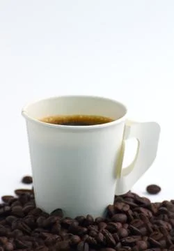 Steaming  paper coffee cup with beans on white background Stock Photos