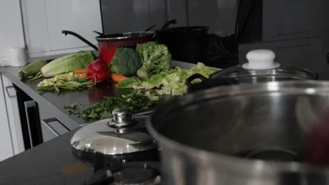 Steaming pot on the fire vegetables in the background soft focus 스톡 동영상 137211251
