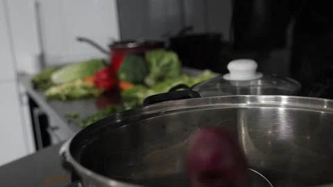 Steaming pot on the fire vegetables in the background rack focus Stock Footage 137211252