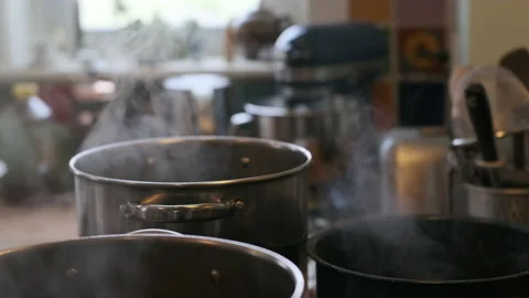 Steaming pots on stove in realistic kitchen. Stock Footage 130367112