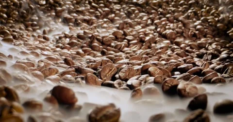 Steaming roasted coffee beans background with selective focus. Stock Footage 345582942