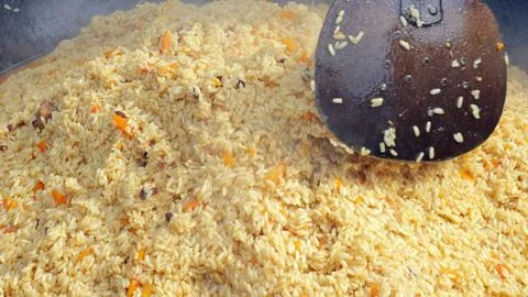 Steaming saffron rice served elegantly, Closeup of rice steaming with spices and Stock Photos